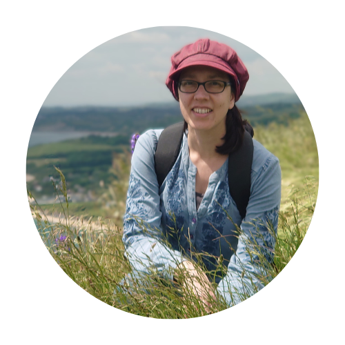 Image of Farah Egby kneeling in long grass in the countryside