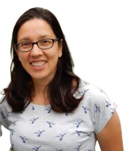 Farah Egby portrait: beige woman with glasses and dark hair
